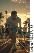 A group of young athletes sprints on a track as the sun sets behind palm trees. Стоковое AI-изображение, AI-художник Данила Большаков / Фотобанк Лори