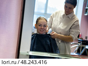 Woman Enjoys Hair Transformation in a Cozy Salon Atmosphere With a Skilled Stylist. Стоковое фото, фотограф Aleksandr Golubev / Фотобанк Лори