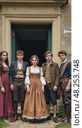 A group of people in historical costumes standing in front of an old building, front view, daylight lighting, historical color palette. Стоковое AI-видео, аниматор Sergey Grishin / Фотобанк Лори
