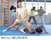 Teenage girl practicing painful armlock in sparring with instructor at self defence training. Стоковое фото, фотограф Яков Филимонов / Фотобанк Лори