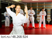 Woman in kimono showing fight stance during karate training. Стоковое фото, фотограф Яков Филимонов / Фотобанк Лори