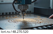 A close-up of a worker's hands operating a CNC machine, metal shavings scattering as the machine carves a precise design under control of operator. Стоковое AI-видео, аниматор Sergey Grishin / Фотобанк Лори