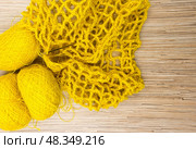 Yellow colored skeins of jute twine for crocheting on white wooden background. Стоковое фото, фотограф Татьяна Васильева / Фотобанк Лори