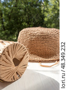 The process of knitting a raffia hat, a skein of yarn, a hook on a wooden background. Стоковое фото, фотограф Татьяна Васильева / Фотобанк Лори