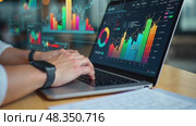 Man is typing on a laptop with a screen displaying various graphs and charts. Стоковое AI-видео, аниматор Sergey Grishin / Фотобанк Лори
