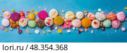 Delightful Sweet Treat: Array of Colorful Confectioneries on Bright Blue Backdrop. Стоковое AI-изображение, AI-художник Данила Большаков / Фотобанк Лори