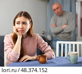 Portrait of a frustrated woman, while husband scolds her. Стоковое фото, фотограф Яков Филимонов / Фотобанк Лори