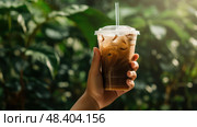 holdg iced coffee in plastic cup ai generated. Стоковое AI-изображение, AI-художник Vectorwin / Фотобанк Лори
