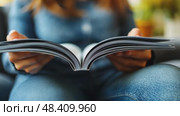 Woman reading a book/novel in a relaxed pose, engrossed in the story, suggesting leisure, learning, and literary exploration. Стоковое AI-видео, аниматор Данила Большаков / Фотобанк Лори