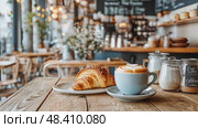 Cozy cafe scene: Latte and croissant breakfast. Warm, inviting ambiance with fresh pastry, coffee aroma, and relaxing setting. Стоковое AI-видео, аниматор Данила Большаков / Фотобанк Лори