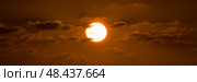 Beatiful sunset above the mediterranean sea. Sunrise with red and orange skies and the sun shining. Bright sun with dark background. Стоковое фото, фотограф Сергей Богомяко / Фотобанк Лори
