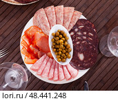 Meat platter from pork loin, salami, blood sausage with olives. Стоковое фото, фотограф Яков Филимонов / Фотобанк Лори