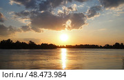 Witness captivating transformation as sun gracefully sinks below horizon over Sava River. Time lapse sunset. Vivid colors dance across sky, silhouettes of trees. Stunning backdrop. Serbia at spring. Стоковое видео, видеограф Юлия Петровская / Фотобанк Лори