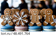A row of gingerbread men with snowflakes on them. Стоковое AI-изображение, AI-художник Ярославский Максим / Фотобанк Лори