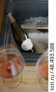 Russia, St.Petersburg, 24 April 2025: bottle of champagne is cooled in a niche with ice in the restaurant, local lighting, wine cabinet, decanters for sparkling wine. Редакционное видео, видеограф Vladimir Drozdin / Фотобанк Лори