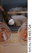 Russia, St.Petersburg, 24 April 2025: bottle of champagne is cooled in a niche with ice in the restaurant, local lighting, wine cabinet, decanters for sparkling wine. Редакционное видео, видеограф Vladimir Drozdin / Фотобанк Лори