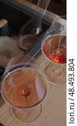 wine glasses of rose champagne is cooled in a niche with ice in the restaurant, local lighting, wine cabinet, decanters for sparkling wine. Стоковое видео, видеограф Vladimir Drozdin / Фотобанк Лори