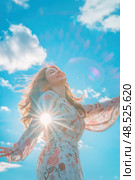 A joyful woman with arms outstretched basks in the warm sunlight against a vivid blue sky. Стоковое AI-изображение, AI-художник Данила Большаков / Фотобанк Лори