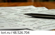 A pen rests on a stack of papers, ready for notes or signatures. The papers are neatly arranged underneath the pen. Стоковое AI-изображение, AI-художник Данила Большаков / Фотобанк Лори