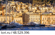 VALLETTA, MALTA - NOVEMBER 12, 2018 - The Grand Harbor Tricity bay, Birgu and Senglea islands with ships and boats in the port. Редакционное фото, фотограф Сергей Богомяко / Фотобанк Лори
