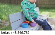 caucasian child boy kid playing sandbox sand plastic molds outside yard sunny day. Стоковое видео, видеограф Olesia Kondrateva / Фотобанк Лори