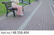 female pink dress white coat sit city park bench stand go away walk on camera. Стоковое видео, видеограф Olesia Kondrateva / Фотобанк Лори