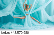Aerial Grace: A dancer suspended in flowing aqua silk. Стоковое AI-изображение, AI-художник Данила Большаков / Фотобанк Лори