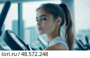 Fitness journey: Portrait of a girl at the gymnasium. Стоковое AI-изображение, AI-художник Данила Большаков / Фотобанк Лори