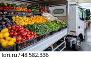 A market truck is filled with an array of colorful fruits and vegetables, inviting customers to explore fresh produce amidst a lively atmosphere. Стоковое AI-изображение, AI-художник Данила Большаков / Фотобанк Лори