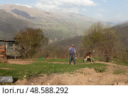 А man and a donkey looking at the mountains. View of the mountains in Armenia. Village in Tavush region. Редакционное фото, фотограф Evgenia Shevardina / Фотобанк Лори