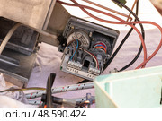 Repair of a large boiler gas burner, analysis of parts on the table: the inside of the servo motor with wires. Serbia, Pancevo, October 1, 2019. Редакционное фото, фотограф ok_fotoday / Фотобанк Лори
