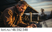 Skilled man diligently works on a solar panel, channeling the raw power of the sun into a sustainable energy source. Стоковое AI-изображение, AI-художник Данила Большаков / Фотобанк Лори