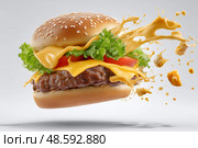 Delicious cheeseburger with exploding toppings in a creative food design. Вкусный чизбургер со взрывающейся начинкой в креативном дизайне еды. Стоковое AI-изображение, AI-художник Katsiaryna Repich / Фотобанк Лори