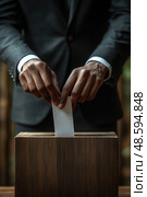 A voter in formal attire places a ballot into a wooden box, emphasizing civic duty in a peaceful outdoor environment. Стоковое AI-изображение, AI-художник Данила Большаков / Фотобанк Лори