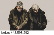 Sorrowful Senior Pair: A portrait of an elderly couple in weathered clothing, heads bowed in a moment of shared contemplation, evoking melancholy. Стоковое AI-изображение, AI-художник Данила Большаков / Фотобанк Лори