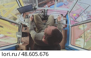 View of the crane operator's driver in the cabin, top view. He manages the loading of coal onto the barge. Working professions are men at work. Стоковое видео, видеограф Владимир Разгуляев / Фотобанк Лори