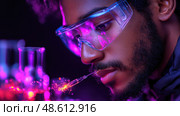 An enthusiastic scientist carefully analyzes vibrant liquids in test tubes, demonstrating a deep commitment to scientific exploration in a lab setting. Стоковое AI-изображение, AI-художник Данила Большаков / Фотобанк Лори