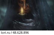An elderly woman lights a dark magic candle in the night fog. Стоковое AI-видео, аниматор Виктория Новохацкая / Фотобанк Лори