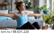 Woman practicing yoga indoors at home during morning routine for relaxation and improved well-being. Стоковое AI-изображение, AI-художник Сергей Толмачёв / Фотобанк Лори