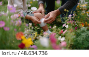 Caring moment in a flower garden as a parent helps child with a scraped knee during sunny afternoon. Стоковое AI-изображение, AI-художник Сергей Толмачёв / Фотобанк Лори