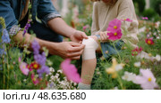 Caring for a child's scraped knee in a vibrant flower garden during sunny spring afternoon. Стоковое AI-изображение, AI-художник Сергей Толмачёв / Фотобанк Лори