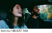 Friends enjoy a joyful road trip while singing together in a car on a sunny day. Стоковое AI-изображение, AI-художник Сергей Толмачёв / Фотобанк Лори