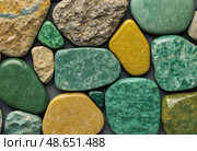 Displaying a variety of unakite stones, this captivating arrangement features epidosite and coarse-grained metamorphic rock with vibrant colors that highlight their natural beauty Generative AI. Стоковое AI-изображение, AI-художник Юлия Петровская / Фотобанк Лори
