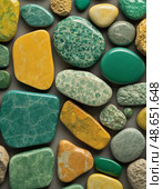 Exploring a stunning array of unakite stones, showcasing their rich green and orange colors, diverse shapes, and interesting textures. Each stone tells its own geological story Generative AI. Стоковое AI-изображение, AI-художник Юлия Петровская / Фотобанк Лори