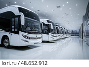 Fleet of modern buses in a well-lit transportation hub. Стоковое AI-изображение, AI-художник Михаил Коханчиков / Фотобанк Лори