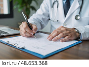 Врач заполняет медицинскую карту пациента / Doctor filling out a patient's medical chart. Стоковое AI-изображение, AI-художник Валерий Лукин / Фотобанк Лори