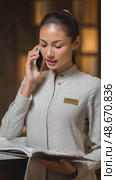 Hotel receptionist managing bookings and answering calls. Стоковое AI-видео, аниматор Юрий Поздников / Фотобанк Лори