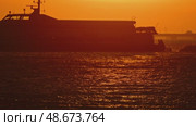 Passenger ferry sailing at sunset near bridge. Стоковое видео, видеограф Константин Шишкин / Фотобанк Лори