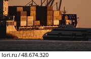 21 may 2025, Lisbon. Portugal - Ferry passing by a large container ship at sunset. Редакционное видео, видеограф Константин Шишкин / Фотобанк Лори