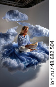 A woman is reading a book while floating in the air. Стоковое AI-изображение, AI-художник Ярославский Максим / Фотобанк Лори